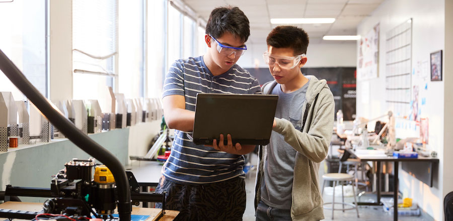 two students in engineering lab using laptop