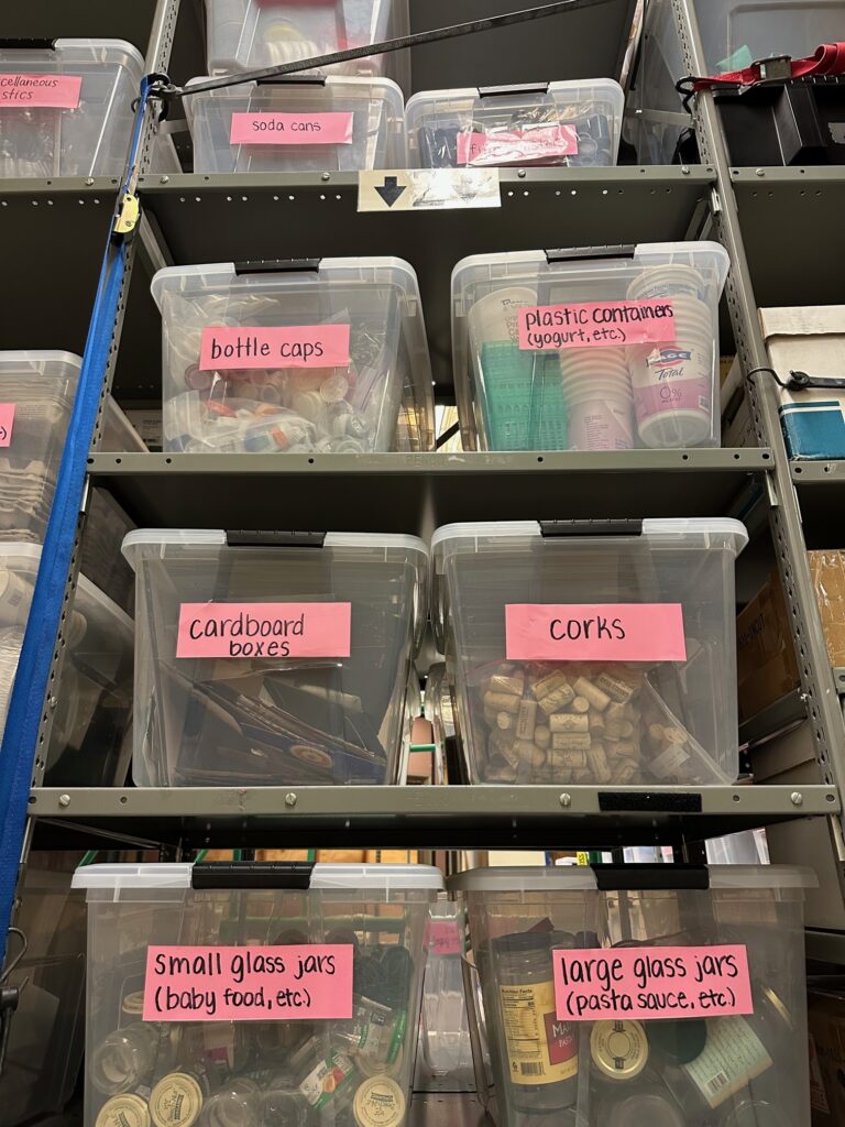 Prep hub supplies including corks, cardboard boxes, glass jars, plastic containers, and more.